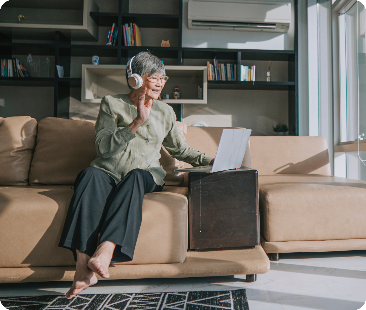 Elderly woman video chatting on laptop